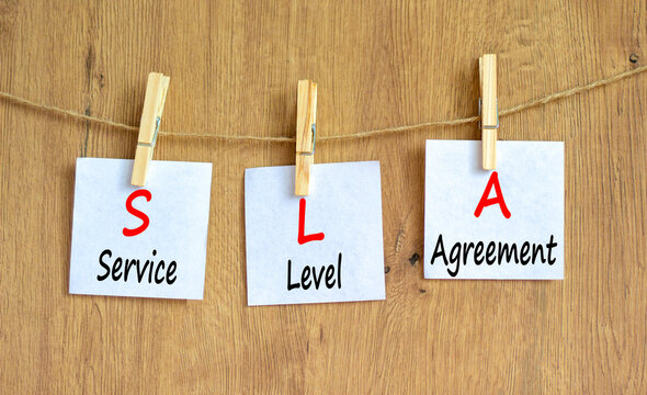 SLA service level agreement symbol. Concept words SLA service level agreement on beautiful white paper. Beautiful wooden background. Business SLA service level agreement concept. Copy space.