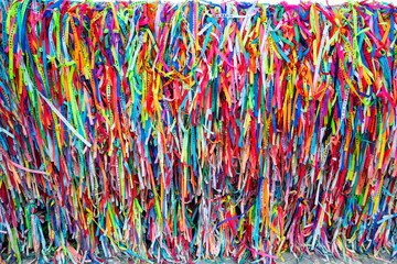 Colorful cloth ribbons used as bracelets with the belief of attracting protection and good luck,  Arraial D'Ajuda, Bahia, Brazil, Feb 2022