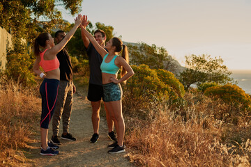 People, group and high five or mountain exercise as trail running support, fitness or victory. Men,...