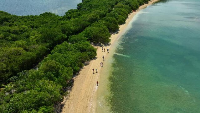 Aerial drone footage, showing people strolling down a pristine beach near Fajardo, Puerto Rico.