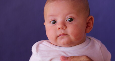 Portrait of cute newborn baby infant boy observing