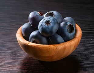 Blueberries on a wooden bowl on a wooden table. Fruits and summer berries