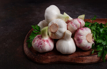 Fresh young garlic, white and purple color, on a wooden table, no people,