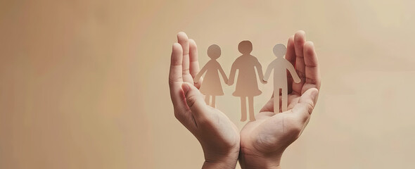 Paper cutout of a family silhouette held in hands, on a warm beige background, concept for care and support to families with children, stock photo contest winner, high resolution