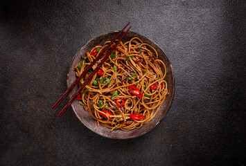 udon noodles, with shimeji mushrooms, vegetables, in sauce, with sesame seeds, green onions, Asian...