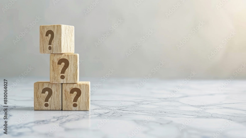 Poster tower of curiosity: a stack of wooden blocks with question marks