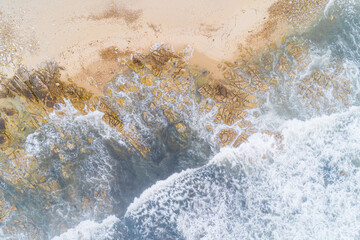 directly above drone view of a rocky beach shore