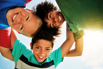 Happy, blue sky and low angle portrait of children for friendship, playing and fun together....