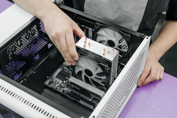 system administrator installing motherboard into system unit, assembling PC of different...