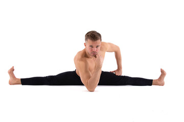 A young attractive man with an athletic body is doing yoga. White background.