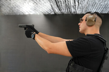 The man practicing shooting pistol at the shooting range.