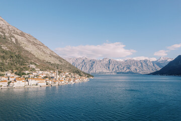 View from the sea on the coast of the ancient town of Perast at the foot of the mountains. Montenegro. Drone