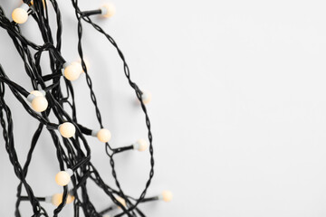 Beautiful Christmas lights on white background, top view