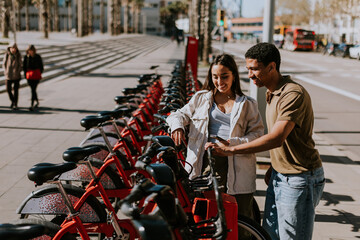 Intimate moment shared between a couple selecting public bicycles in sunny Barcelona