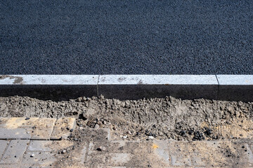 New asphalt and curb after repair