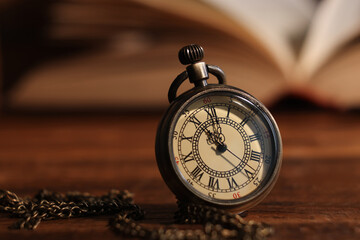 Pocket clock with chain on table, closeup