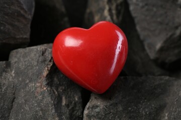 Obraz premium One red decorative heart on stones, closeup