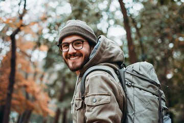 Obraz premium Happy young man carrying backpack outdoors