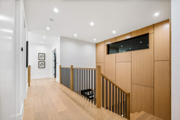 Hallway With Wooden Railing and Black and White Picture