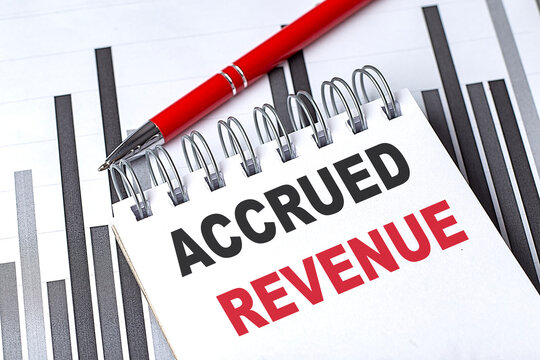 ACCRUED REVENUE text on notebook on chart with pen