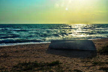 The Sea of Azov in a storm, ground swell. A fishing boat on the shore is overturned. Arabatskaya...