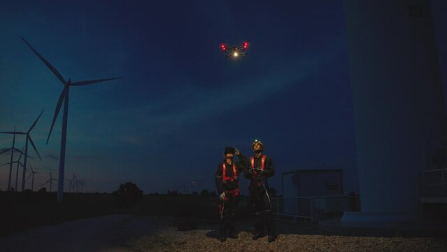 Maintenance engineers are using drones to survey wind turbines.