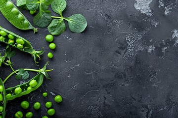 Green young peas on a dark stone background. View from above. place for text. 