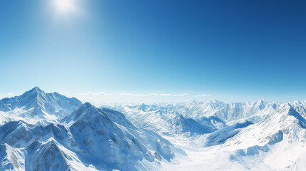 Obraz premium Snow-covered mountain range under a clear blue sky, serene winter landscape
