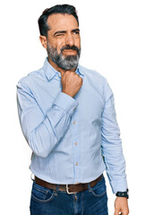 Middle aged man with beard wearing business shirt touching painful neck, sore throat for flu, clod and infection