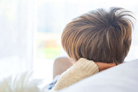 enfant et mal &agrave; l'oreille, assis sur le canap&eacute; &agrave; la maison