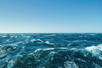 The vast ocean with rough waves with clear blue sky background