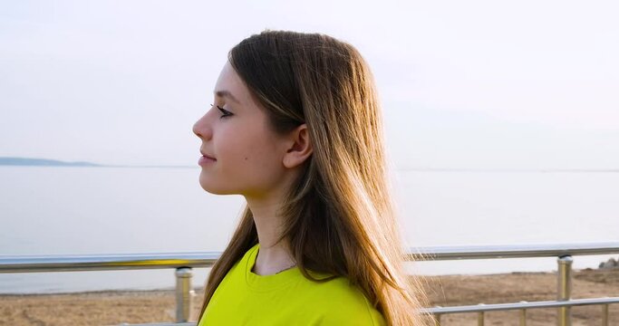 A happy young teenage girl walks along the city embankment, bouncing and running. Weekend activity concept. Samara, Russia - 29 April 2024