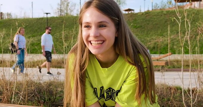 Young teen girl laughing outside, close-up video. Samara, Russia - 29 April 2024