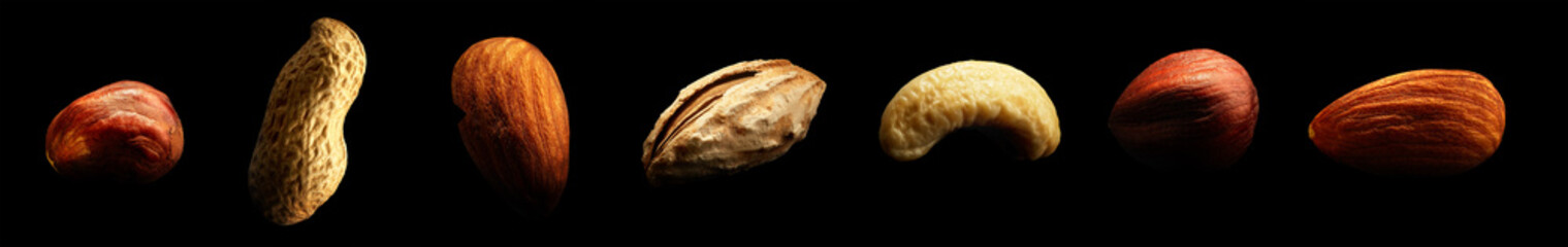 Group of nuts isolated on black background. Close-up