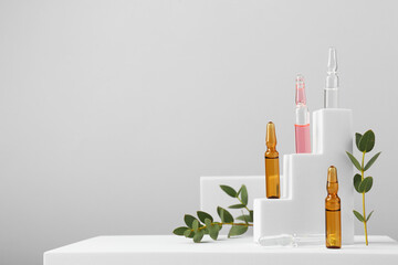 Stylish presentation of different skincare ampoules on white background. Space for text