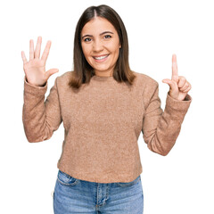 Young beautiful woman wearing casual clothes showing and pointing up with fingers number seven while smiling confident and happy.