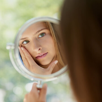 Woman, mirror and anti aging for beauty in home, hands and skincare or critical and thinking with natural reflection. Facial wellness, dermatology and cosmetic or inspection, treatment and self care