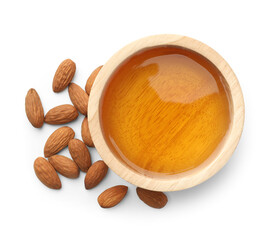 Almond oil in bowl and nuts isolated on white, top view
