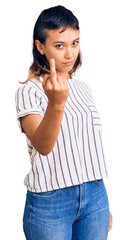 Young woman wearing casual clothes showing middle finger, impolite and rude fuck off expression