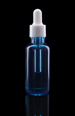 One blue bottle with tincture on mirror surface against black background