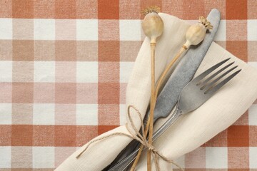 Stylish setting with cutlery and napkin on table, top view. Space for text