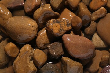 Beautiful pebbles in water as background, top view