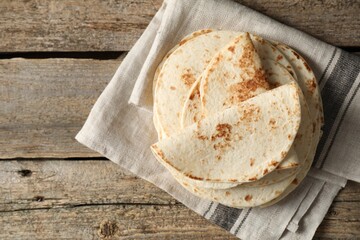 Tasty homemade tortillas on wooden table, top view