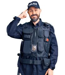 Young handsome man wearing police uniform smiling pointing to head with one finger, great idea or thought, good memory