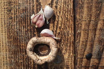 Garlic Dried herbs and champignon on the vintage wooden background, top view
