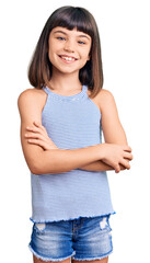 Young little girl with bang wearing casual clothes happy face smiling with crossed arms looking at...