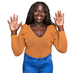 Young african woman wearing casual clothes showing and pointing up with fingers number nine while...