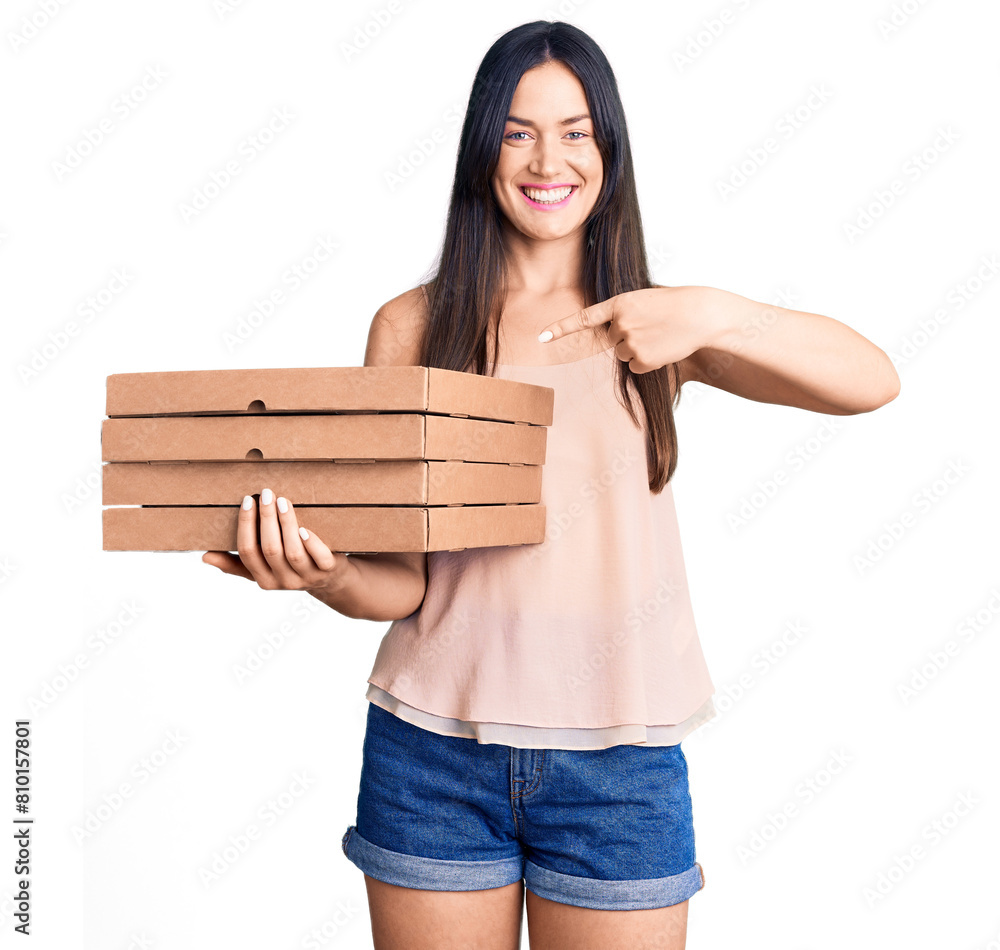 Poster Young beautiful caucasian woman holding delivery pizza box smiling happy pointing with hand and finger