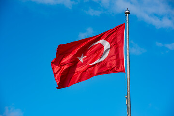 Turkish Flag waving in blue sky.