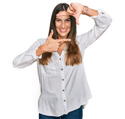 Young beautiful woman wearing casual clothes smiling making frame with hands and fingers with happy face. creativity and photography concept.
